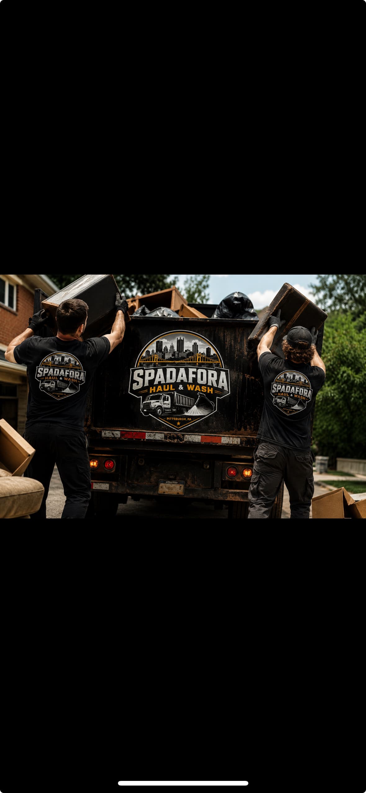 Two workers loading furniture into a Spadafora Haul & Wash truck for junk removal.